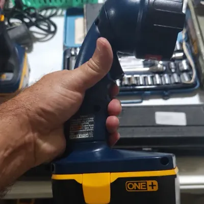 Sale Photo Thumbnail #380: Handheld Ryobi ONE+ 18-volt cordless swivel work light with attached battery pack.