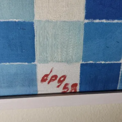 Sale Photo Thumbnail #42: Detail of an abstract grid painting on canvas, signed 'dpg 58' in red paint at the bottom.