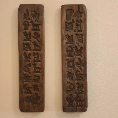 Sale Photo Thumbnail #243: Pair of vintage hand-carved wooden cookie or butter molds featuring various animal and motif relief patterns.