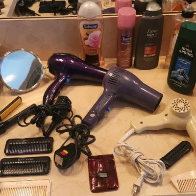 Sale Photo Thumbnail #117: Collection of personal care and grooming items, including vintage hair dryers, styling tools, toiletries, and first aid supplies.