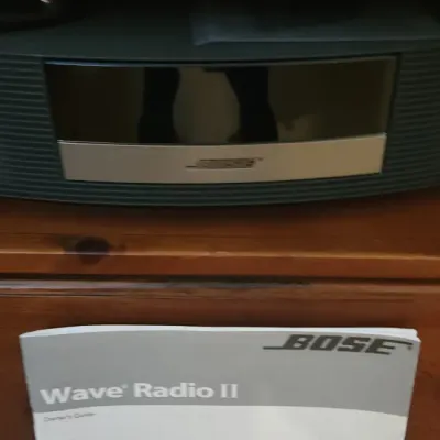 Sale Photo Thumbnail #162: Bose Wave Radio II system in graphite gray, accompanied by a remote control and the original owner's manual.