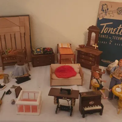 Sale Photo Thumbnail #4: Collection of vintage dollhouse furniture, figures, and miniatures, including wooden pieces, a tiny sewing machine, piano, and a vintage Tonette music book.