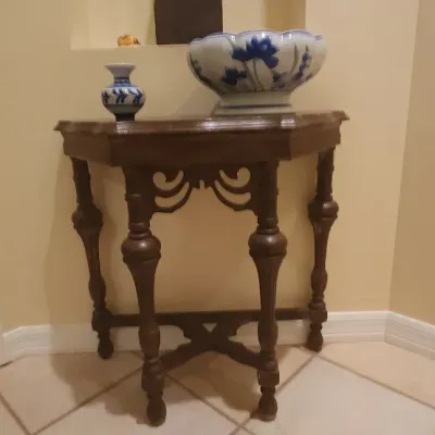 Sale Photo Thumbnail #132: Vintage dark wood console table with turned legs and carved apron, topped with a blue and white ceramic bowl and small matching vase.