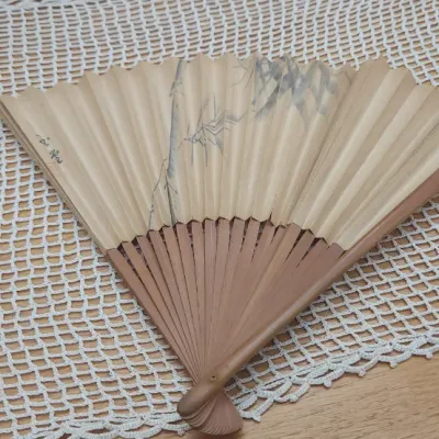 Sale Photo Thumbnail #305: Vintage East Asian hand-painted paper folding fan with wooden ribs, featuring a delicate ink illustration of bamboo shoots.