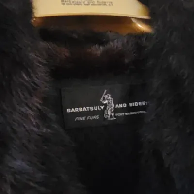 Sale Photo Thumbnail #93: Vintage dark fur coat featuring a Barbatsuly and Sideris Fine Furs woven designer label and a matching branded hanger.