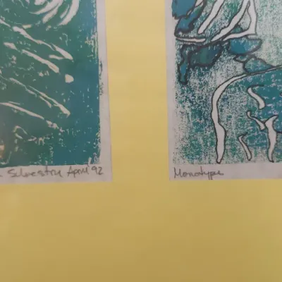 Sale Photo Thumbnail #320: Framed original monotype art prints by Lisa Silvestri, dated April 1992, featuring abstract blue and green linocut-style designs.
