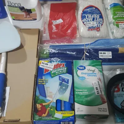 Sale Photo Thumbnail #367: Collection of assorted household cleaning supplies and tools, including a Glass Wizard tool, Windex Outdoor cleaner, mop refills, disposable gloves, and floor cleaning solutions.