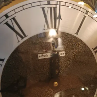 Sale Photo Thumbnail #25: Seth Thomas grandfather clock face featuring Roman numerals, a textured brass center, ornate corner spandrels, and a 'Tempus Fugit' globe arch above.