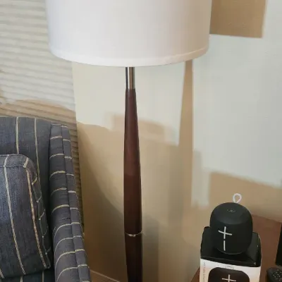 Sale Photo Thumbnail #164: Mid-century modern style floor lamp featuring a tapered dark wood shaft, brushed metal base, and a white drum shade.