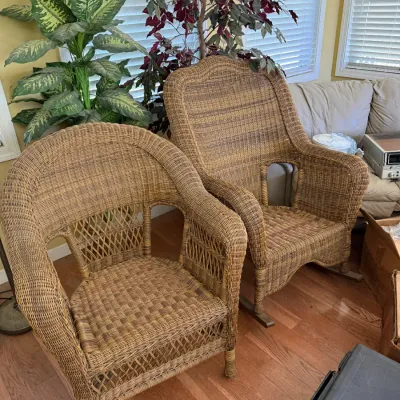 Sale Photo Thumbnail #56: Pair of vintage natural wicker armchairs, including one high-back rocking chair and one stationary armchair, both featuring intricate lattice weave details.