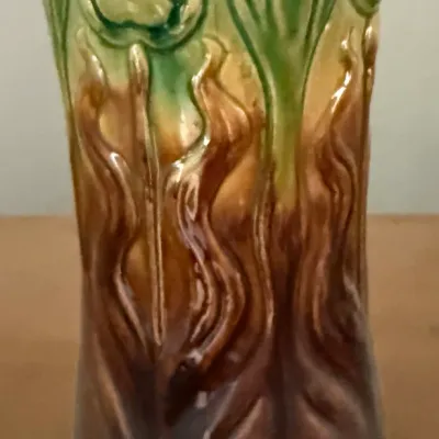 Sale Photo Thumbnail #20: Art Nouveau majolica ceramic vase featuring raised floral motifs with a green and brown blended glaze.