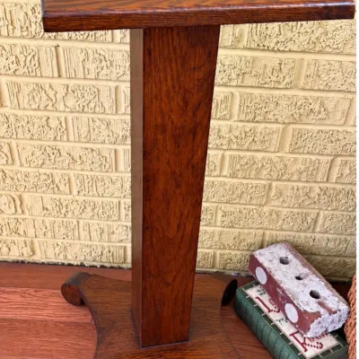 Sale Photo Thumbnail #19: Antique Mission Arts and Crafts style oak plant stand or pedestal featuring a square top and scroll-detailed quadrupod base.