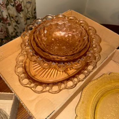 Sale Photo Thumbnail #7: Vintage pink Depression-style glass set featuring open-lace edging and a diamond-pattern bowl stacked inside a cardboard box.