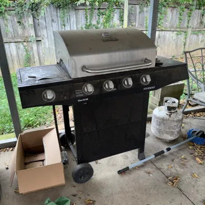 Sale Photo Thumbnail #49: Char-Broil Performance stainless steel and black 4-burner liquid propane gas grill with side burner.