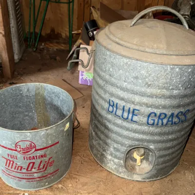 Sale Photo Thumbnail #48: Vintage galvanized metal containers, including a 5-gallon Blue Grass cooler dispenser with spigot and a Frabill's Min-O-Life floating minnow bucket.