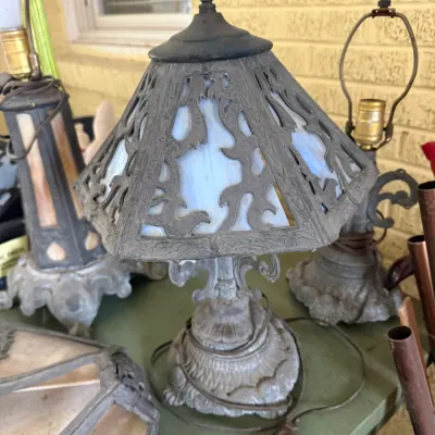 Sale Photo Thumbnail #31: Antique Art Nouveau slag glass boudoir lamp with a detailed cast metal overlay shade and ornate base.