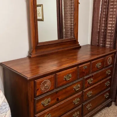 Sale Photo Thumbnail #18: Vintage Colonial Revival pine dresser with matching attached mirror, featuring brass bail handles and carved rosette accents.