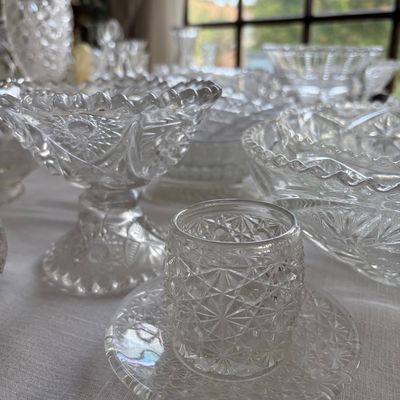 Sale Photo Thumbnail #32: Vintage pressed glass from the early 1900s. Shown is a compote and button-and-daisy attached cup and saucer.