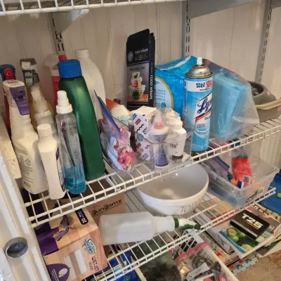Sale Photo Thumbnail #23: Assorted household cleaning supplies, spray bottles, Lysol disinfectant, food wraps, and storage containers arranged on wire shelving.