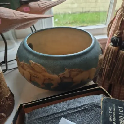 Sale Photo Thumbnail #11: Arts and Crafts style ceramic planter featuring a blue-grey matte glaze with relief-carved running horses along the exterior.
