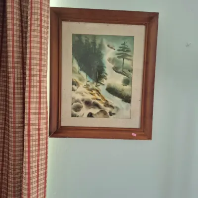 Sale Photo Thumbnail #49: Framed watercolor painting depicting a misty mountain landscape with pine trees and a stream, presented in a wooden frame with a fabric mat.