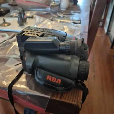 Sale Photo Thumbnail #5: Vintage RCA VHS camcorder with side hand strap and viewfinder, circa late 1980s to early 1990s.