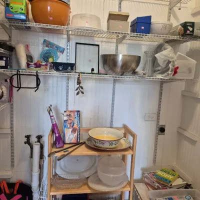Sale Photo Thumbnail #19: Assorted household kitchenware and storage items displayed on white wire shelving and a small wooden utility cart.