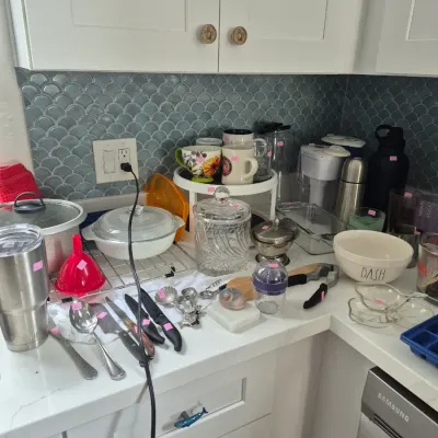Sale Photo Thumbnail #17: Assorted modern kitchenware and small appliances on a countertop, including a Yeti tumbler, CorningWare casserole dish, mugs, and utensils.
