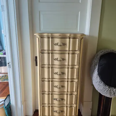 Sale Photo Thumbnail #115: French Provincial style tall narrow lingerie chest featuring a cream painted finish with six drawers and ornate brass hardware.