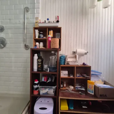 Sale Photo Thumbnail #91: Selection of bathroom organization shelves holding various personal care products, toiletries, and a Lumin UV sanitizer.