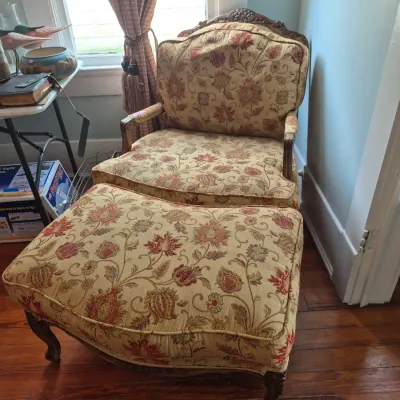 Sale Photo Thumbnail #46: French Provincial style armchair and matching ottoman with carved wood frames and floral upholstery.