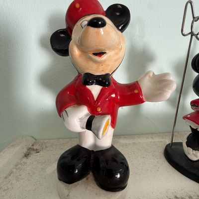Vintage Mickey Mouse ceramic figurine dressed as a bellhop in a red jacket and cap.