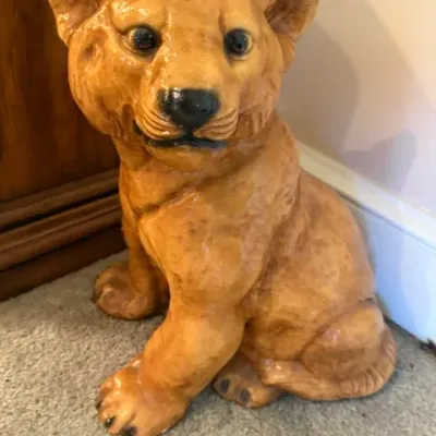 Glazed ceramic lion cub statue featuring hand-painted detail and realistic features.