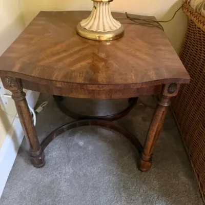 Traditional wooden end table featuring a chevron-patterned veneer top, carved rosette accents, and fluted legs with curved stretchers.