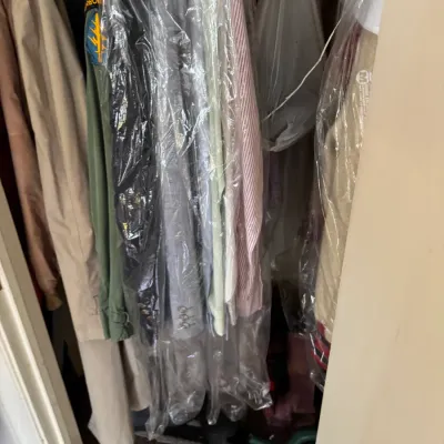Sale Photo Thumbnail #45: Closet filled with assorted vintage clothing, including a military field jacket with patch and dry-cleaned suits.