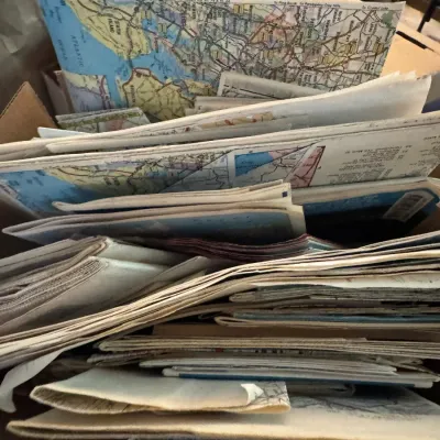 Sale Photo Thumbnail #146: Cardboard box filled with a large collection of vintage folded paper road maps, mostly covering New York and New Jersey.