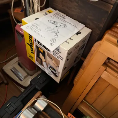 Sale Photo Thumbnail #149: Wagner 705 wallpaper steamer in original box topped with a Craftsman drill manual, sitting alongside household tools and equipment.