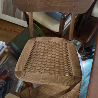 Sale Photo Thumbnail #18: Mid-century Danish modern style dining chair featuring a wooden frame and a woven paper cord seat.