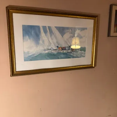 Sale Photo Thumbnail #92: Framed watercolor print depicting sailboats at sea, presented in a matted gilt frame.