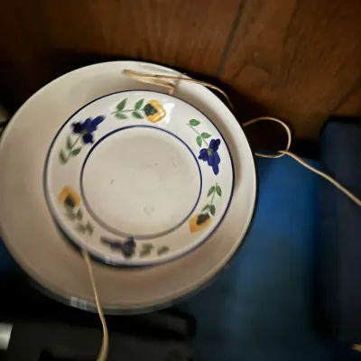 Sale Photo Thumbnail #105: Hand-painted ceramic saucer with blue and yellow floral motifs, stacked inside a larger white dish.