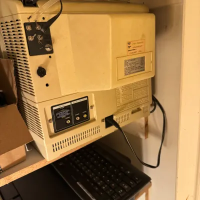 Sale Photo Thumbnail #58: Vintage Sears 13-inch color TV monitor manufactured in February 1986, tucked into a cabinet above a computer keyboard.