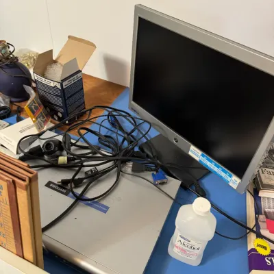 Sale Photo Thumbnail #54: Vintage silver LCD computer monitor paired with a Linksys Wireless-G media extender, accompanied by various power cords and accessories.