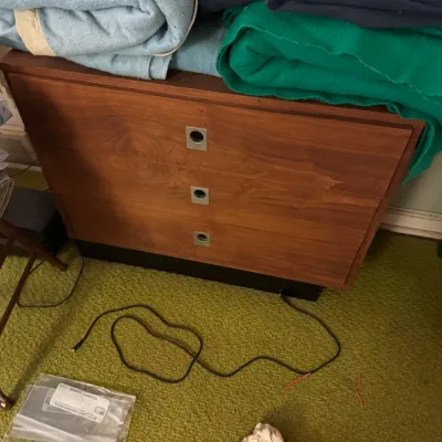 Sale Photo Thumbnail #4: Mid-century modern three-drawer wooden chest featuring square recessed metal hardware and a dark base platform.