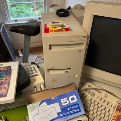 Sale Photo Thumbnail #49: Vintage IBM Aptiva desktop computer tower with matching CRT monitor and keyboard, surrounded by office supplies and electronics from the 1990s.