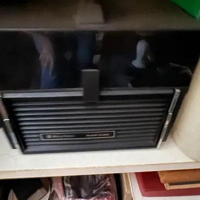 Sale Photo Thumbnail #104: Vintage Bell & Howell Silent 8mm/Super 8 movie projector in a protective black plastic case.