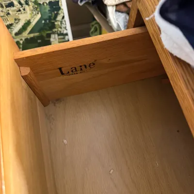 Sale Photo Thumbnail #40: Open wooden furniture drawer displaying an embossed Lane Altavista Virginia brand logo along the inner side panel.