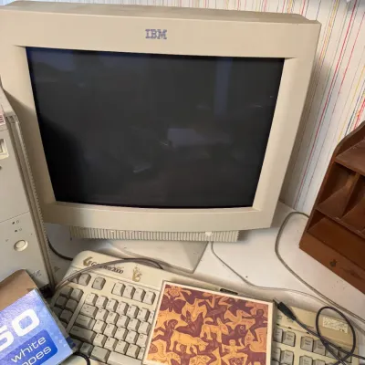 Sale Photo Thumbnail #48: Vintage IBM CRT computer monitor from the 1990s, shown with a Gateway 2000 keyboard and assorted desktop accessories.
