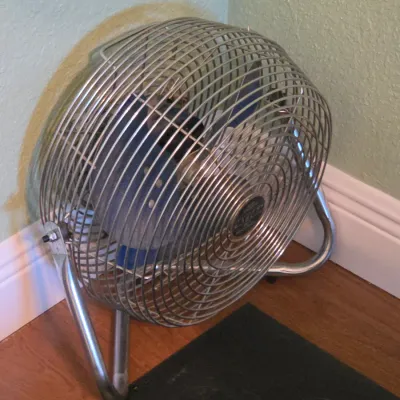 Vintage Patton high-velocity floor fan featuring a chrome cage and tubular steel frame with blue blades.