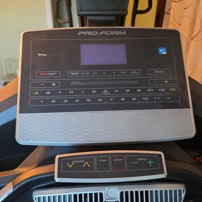 Close-up view of a Pro-Form treadmill console, featuring digital display screens, iFit capability, quick-select incline and speed...