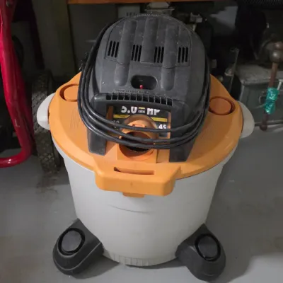 Ridgid 5.0 Peak HP wet/dry shop vacuum on a wheeled caster base with wrapped power cord.